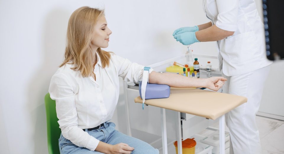 nurse getting a blood sample to check down syndrome